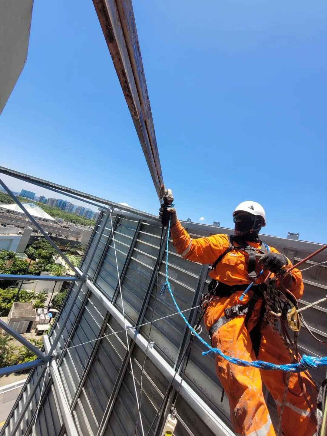 Technician wearing safety equipment at an elevated worksite