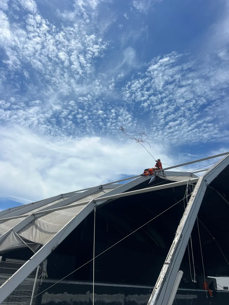 Rope-access work on a roof structure